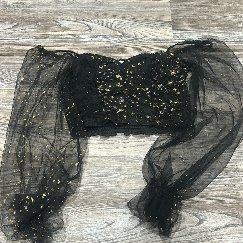 black shirt with gold star accents and poofy sleeves
